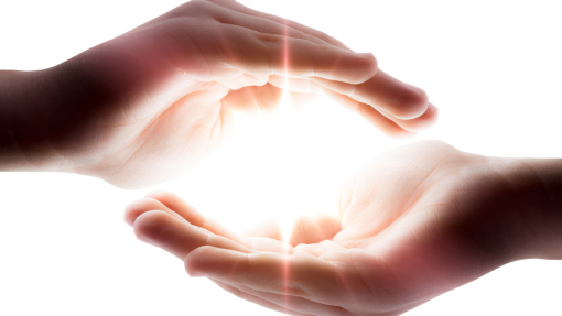 Two hands embracing a bright light in Trauma Treatment.